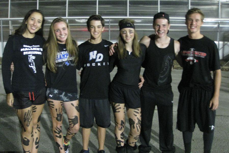 Sophomores, sporting their best black-out attire, gather at West High School for NDAs football game.