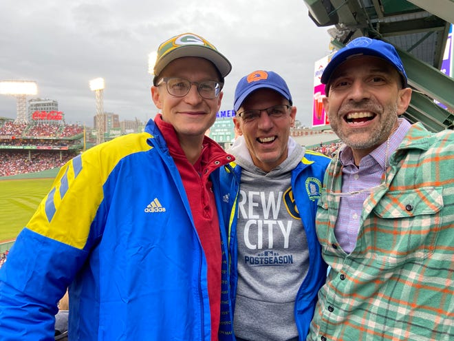 Cross country coaches add the Red Sox-Rays ALDS to their Boston Marathon trip.  From left: Cassidy McGowan, John Gard, Kim Lasecki