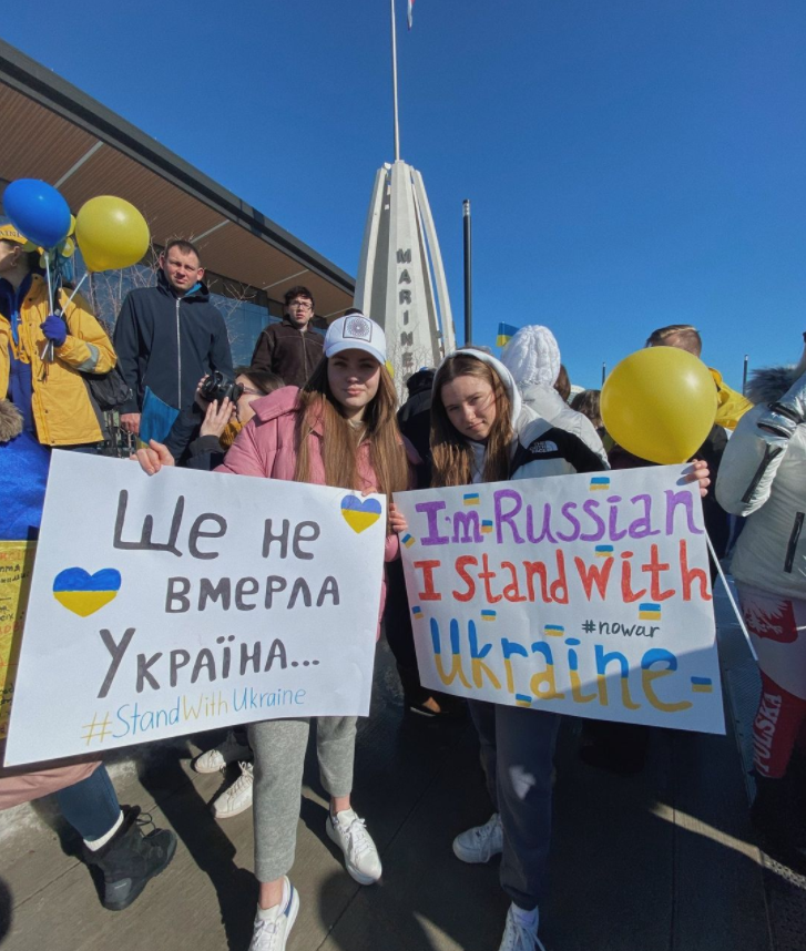 Vlada Klymenko, left, and Milana Volkova, right, protesting war in Ukraine outside the Resch Expo, Ashwaubenon, WI.