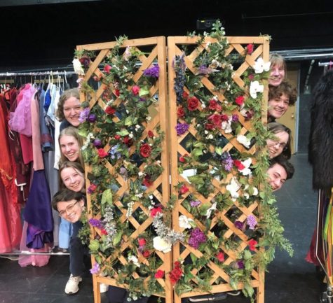 Cast poses with a stage prop ahead of their spring production.