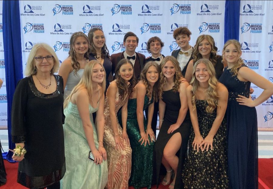NDA musical cast poses for a picture on the red carpet.